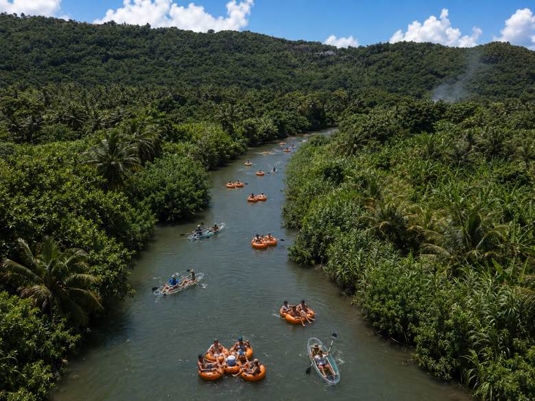 Aerial view of a group rafted up in tubes with kayaks alongside